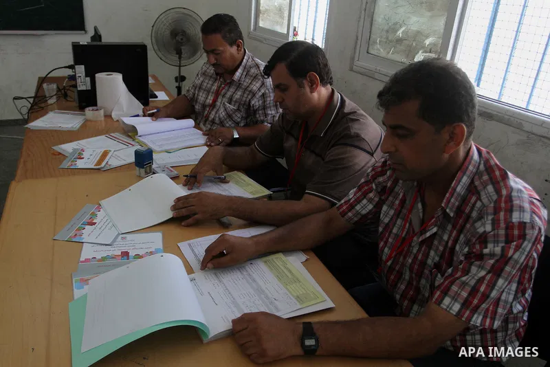 Palestinians from Central Elections Commission (CEO) work at Voter registration centers in Rafah in the southern Gaza strip on July 23, 2016. The Palestinian Central Elections Commission (CEO) announced Saturday that vot...
