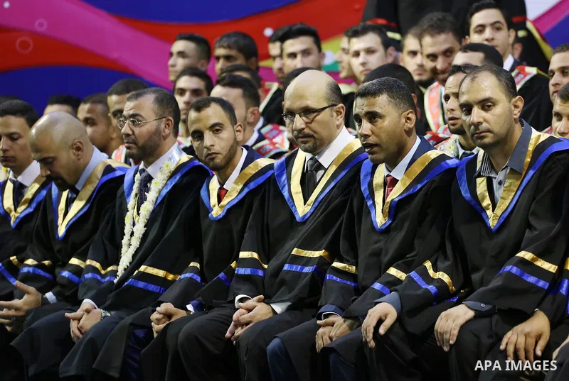 Palestinian students participate in their graduation ceremony at the Islamic University in Gaza city on July 23, 2016. Photo by Mohammed Asad