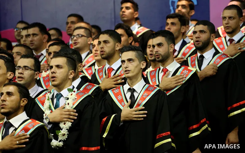 Palestinian students participate in their graduation ceremony at the Islamic University in Gaza city on July 23, 2016. Photo by Mohammed Asad