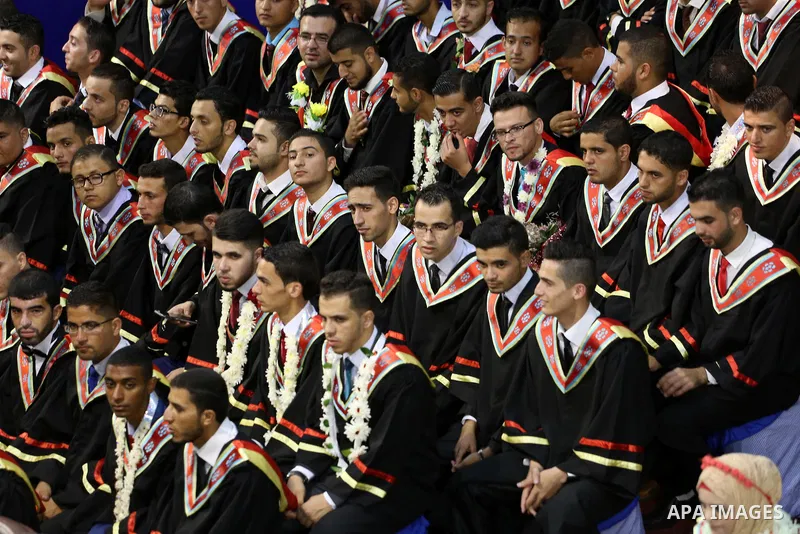Palestinian students participate in their graduation ceremony at the Islamic University in Gaza city on July 23, 2016. Photo by Mohammed Asad