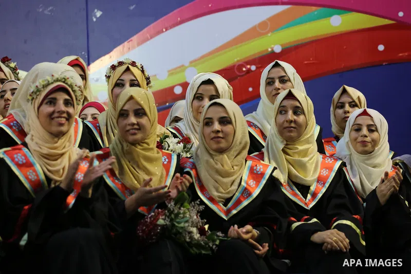 Palestinian students participate in their graduation ceremony at the Islamic University in Gaza city on July 23, 2016. Photo by Mohammed Asad