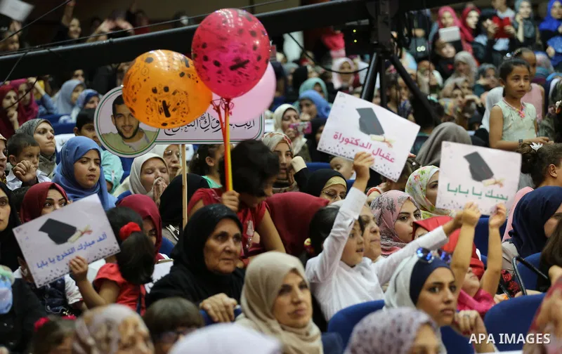 Palestinian students participate in their graduation ceremony at the Islamic University in Gaza city on July 23, 2016. Photo by Mohammed Asad