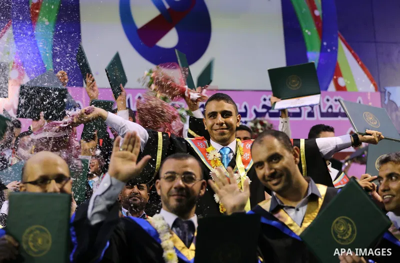 Palestinian students participate in their graduation ceremony at the Islamic University in Gaza city on July 23, 2016. Photo by Mohammed Asad