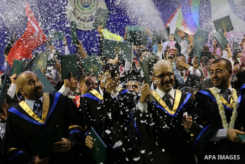 Palestinian students participate in their graduation ceremony at the Islamic University in Gaza city on July 23, 2016. Photo by Mohammed Asad