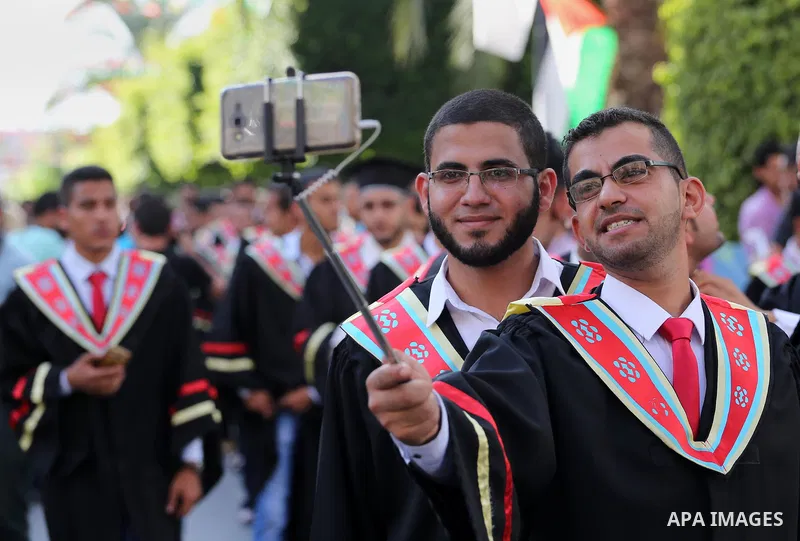 Palestinian students participate in their graduation ceremony at the Islamic University in Gaza city on July 23, 2016. Photo by Mohammed Asad
