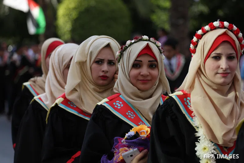 Palestinian students participate in their graduation ceremony at the Islamic University in Gaza city on July 23, 2016. Photo by Mohammed Asad