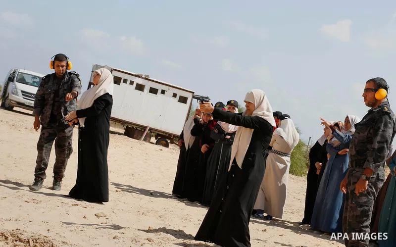 A Palestinian woman fires at a target during a training session for the families of Hamas officials, organized by Hamas-run Security and Protection Service, in Khan Younis in the southern Gaza Strip July 24, 2016. Photo...