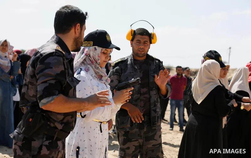 A Palestinian woman fires at a target during a training session for the families of Hamas officials, organized by Hamas-run Security and Protection Service, in Khan Younis in the southern Gaza Strip July 24, 2016. Photo...