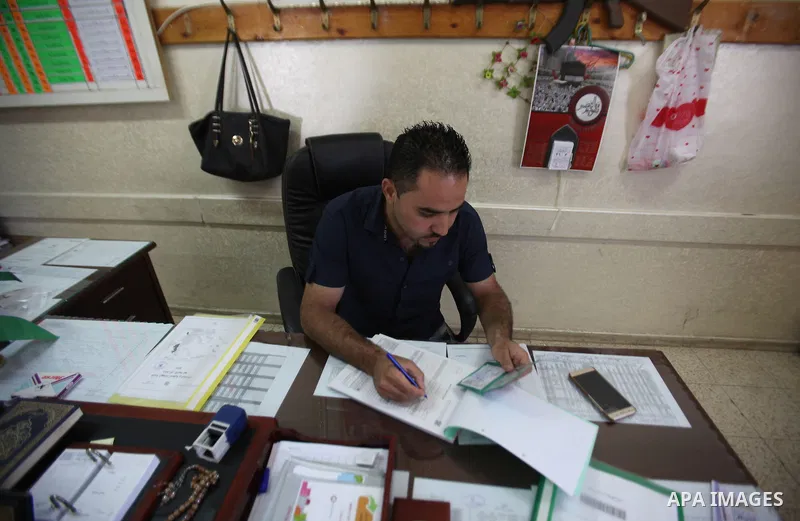 A Palestinian from Central Elections Commission (CEO) works at Voter registration centers in the West Bank city of Nablus on July 24, 2016. The Palestinian Central Elections Commission (CEO) announced Saturday that voter...