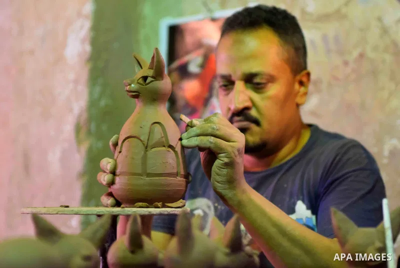 An Egyptian man works at a pottery workshop in Cairo, on July 24, 2016. Pottery is an ancient and traditional craft in Egypt. Local workshops usually produce products such as bowls, pitchers, flower pots, and vases. Phot...