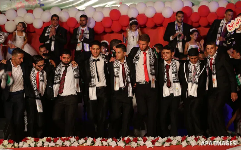 Palestinian grooms take part during a mass wedding for 340 couples organized by Hamas movement in Beit Lahiya town in the northern Gaza Strip July 24, 2016. Photo by Mohammed Asad