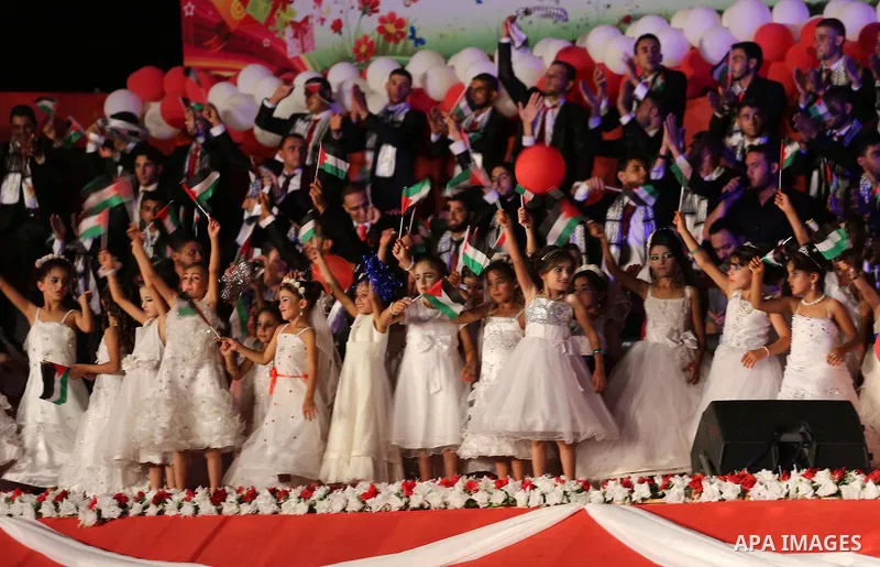 Girls accompany grooms during a mass wedding for 340 couples organized by Hamas movement in Beit Lahiya town in the northern Gaza Strip July 24, 2016. Photo by Mohammed Asad