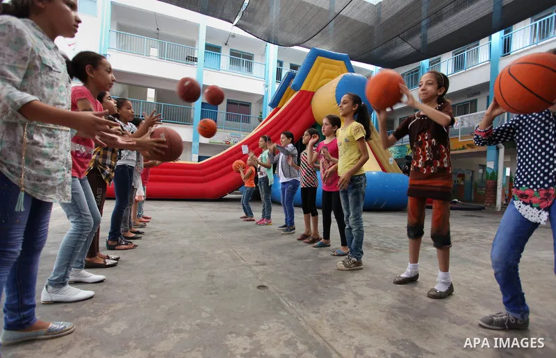 Palestinian schoolgirls enjoy as part of the activities proposed during a summer camp organised by the United Nations on July 25, 2016 in Gaza City. Photo by Ashraf Amra
