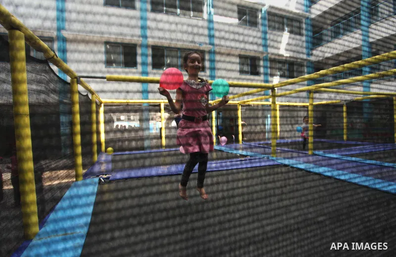 Palestinian schoolgirls enjoy as part of the activities proposed during a summer camp organised by the United Nations on July 25, 2016 in Gaza City. Photo by Ashraf Amra