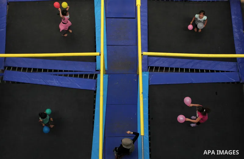 Palestinian schoolgirls enjoy as part of the activities proposed during a summer camp organised by the United Nations on July 25, 2016 in Gaza City. Photo by Ashraf Amra