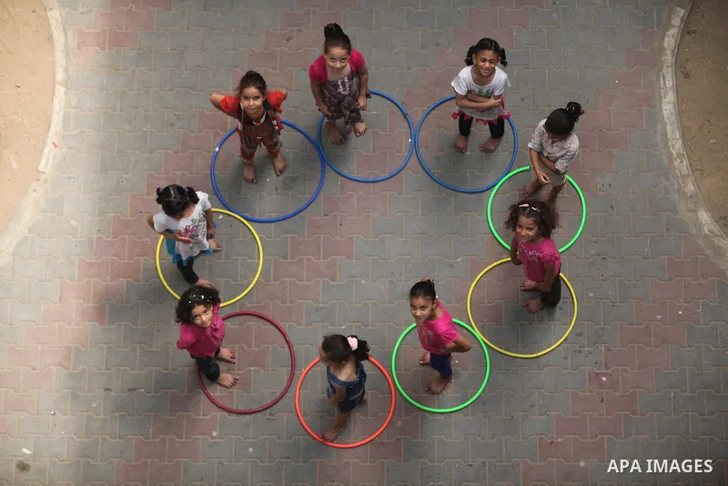 Palestinian schoolgirls enjoy as part of the activities proposed during a summer camp organised by the United Nations on July 25, 2016 in Gaza City. Photo by Ashraf Amra