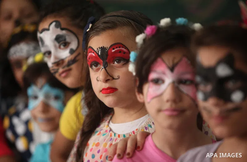 Palestinian schoolgirls enjoy as part of the activities proposed during a summer camp organised by the United Nations on July 25, 2016 in Gaza City. Photo by Ashraf Amra
