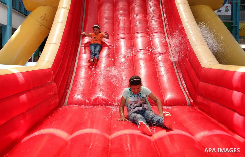 Palestinian schoolgirls enjoy as part of the activities proposed during a summer camp organised by the United Nations on July 25, 2016 in Gaza City. Photo by Ashraf Amra
