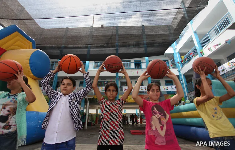 Palestinian schoolgirls enjoy as part of the activities proposed during a summer camp organised by the United Nations on July 25, 2016 in Gaza City. Photo by Ashraf Amra