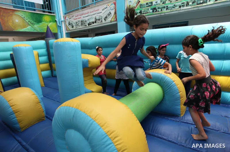 Palestinian schoolgirls enjoy as part of the activities proposed during a summer camp organised by the United Nations on July 25, 2016 in Gaza City. Photo by Ashraf Amra