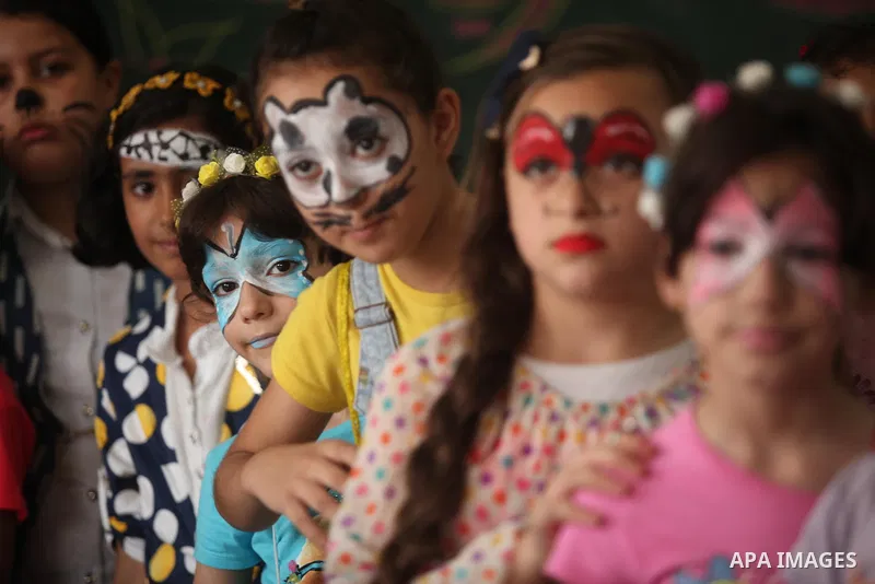 Palestinian schoolgirls enjoy as part of the activities proposed during a summer camp organised by the United Nations on July 25, 2016 in Gaza City. Photo by Ashraf Amra