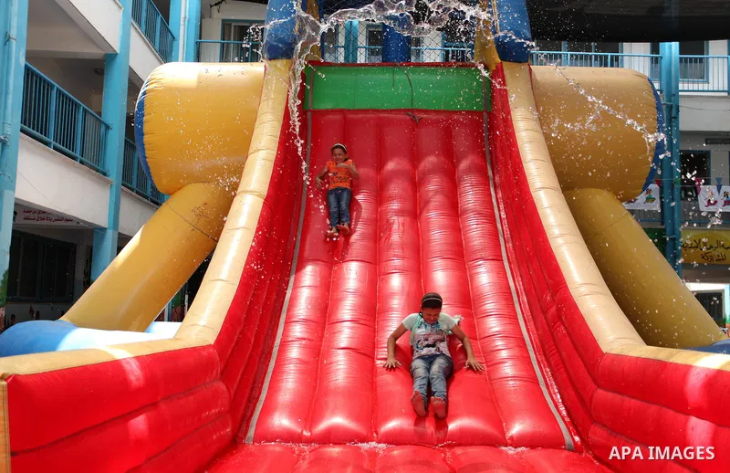Palestinian schoolgirls enjoy as part of the activities proposed during a summer camp organised by the United Nations on July 25, 2016 in Gaza City. Photo by Ashraf Amra