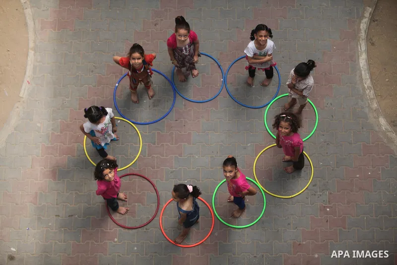 Palestinian schoolgirls enjoy as part of the activities proposed during a summer camp organised by the United Nations on July 25, 2016 in Gaza City. Photo by Ashraf Amra