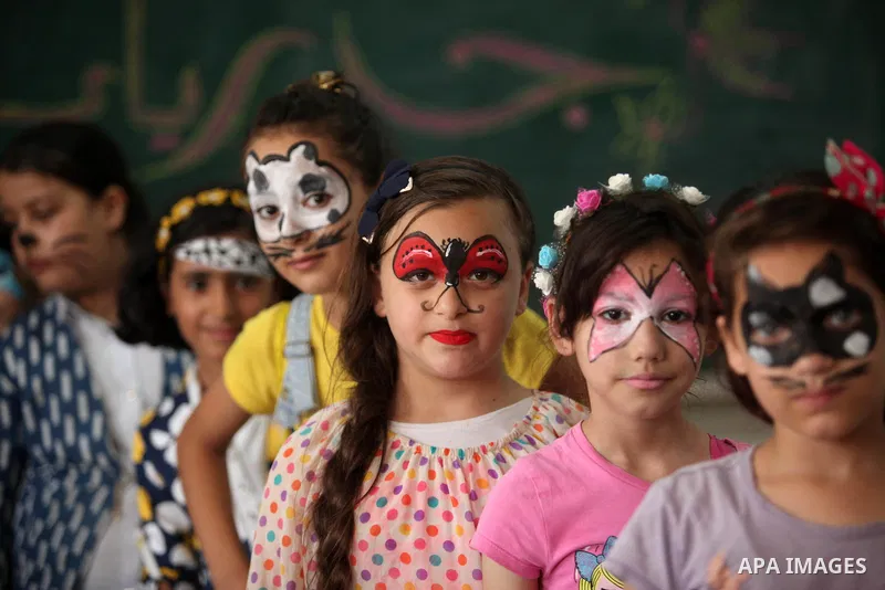 Palestinian schoolgirls enjoy as part of the activities proposed during a summer camp organised by the United Nations on July 25, 2016 in Gaza City. Photo by Ashraf Amra