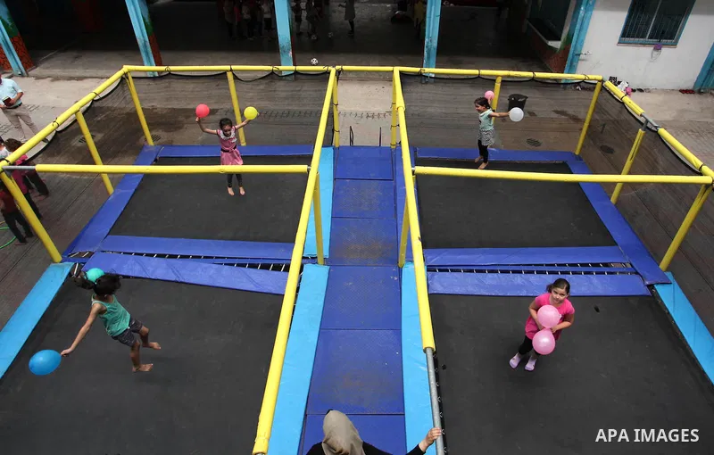 Palestinian schoolgirls enjoy as part of the activities proposed during a summer camp organised by the United Nations on July 25, 2016 in Gaza City. Photo by Ashraf Amra