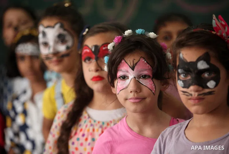 Palestinian schoolgirls enjoy as part of the activities proposed during a summer camp organised by the United Nations on July 25, 2016 in Gaza City. Photo by Ashraf Amra