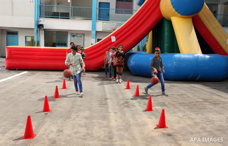 Palestinian schoolgirls enjoy as part of the activities proposed during a summer camp organised by the United Nations on July 25, 2016 in Gaza City. Photo by Ashraf Amra