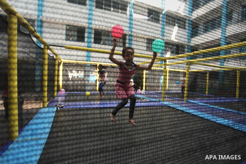 Palestinian schoolgirls enjoy as part of the activities proposed during a summer camp organised by the United Nations on July 25, 2016 in Gaza City. Photo by Ashraf Amra
