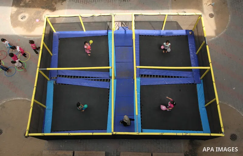 Palestinian schoolgirls enjoy as part of the activities proposed during a summer camp organised by the United Nations on July 25, 2016 in Gaza City. Photo by Ashraf Amra