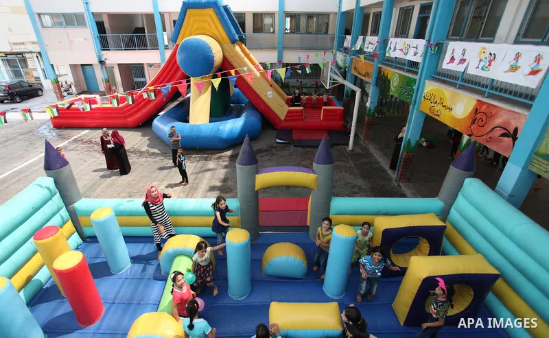 Palestinian schoolgirls enjoy as part of the activities proposed during a summer camp organised by the United Nations on July 25, 2016 in Gaza City. Photo by Ashraf Amra