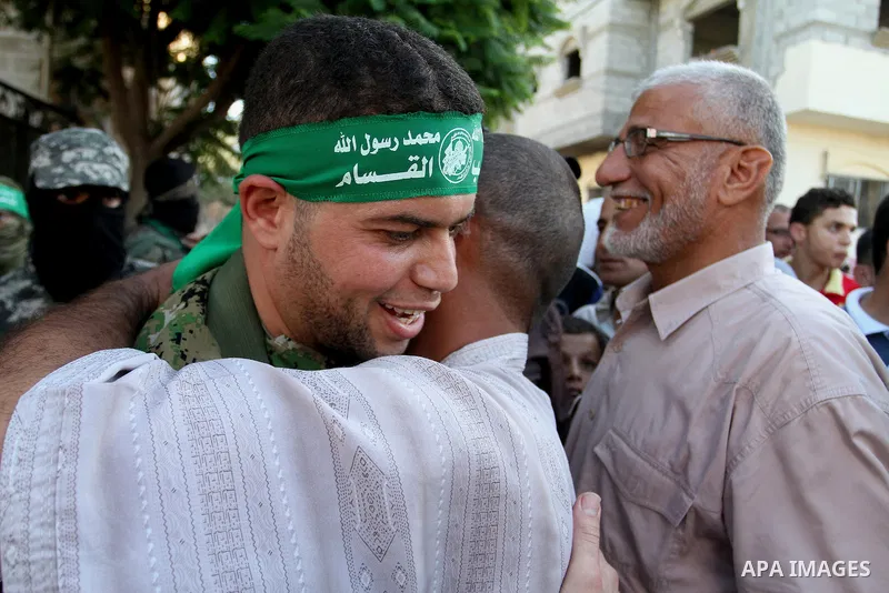 Freed Palestinian prisoner Mohammed al-Bashiti, who served 12 years in an Israeli jail after he was convicted of being a member of Hamas's armed wing is welcomed by relatives in Rafah in the southern Gaza Strip, July 25,...
