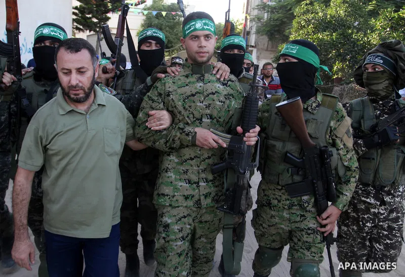 Freed Palestinian prisoner Mohammed al-Bashiti, who served 12 years in an Israeli jail after he was convicted of being a member of Hamas's armed wing is welcomed by Hamas militants in Rafah in the southern Gaza Strip, Ju...