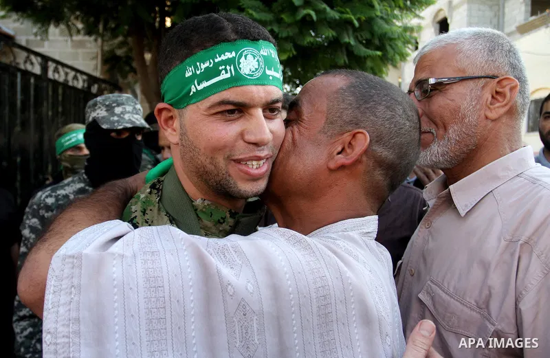 Freed Palestinian prisoner Mohammed al-Bashiti, who served 12 years in an Israeli jail after he was convicted of being a member of Hamas's armed wing is welcomed by relatives in Rafah in the southern Gaza Strip, July 25,...