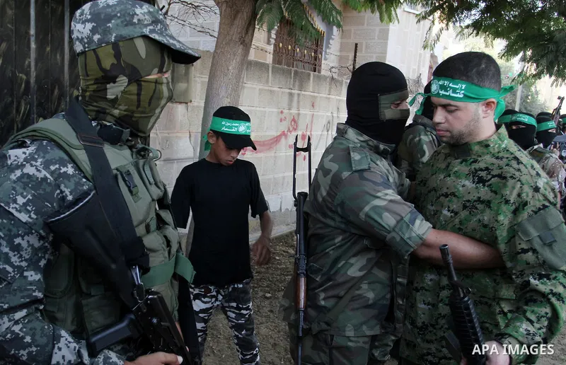 Freed Palestinian prisoner Mohammed al-Bashiti, who served 12 years in an Israeli jail after he was convicted of being a member of Hamas's armed wing is welcomed by Hamas militants in Rafah in the southern Gaza Strip, Ju...