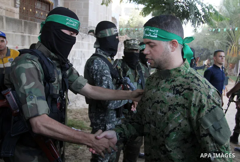 Freed Palestinian prisoner Mohammed al-Bashiti, who served 12 years in an Israeli jail after he was convicted of being a member of Hamas's armed wing is welcomed by Hamas militants in Rafah in the southern Gaza Strip, Ju...