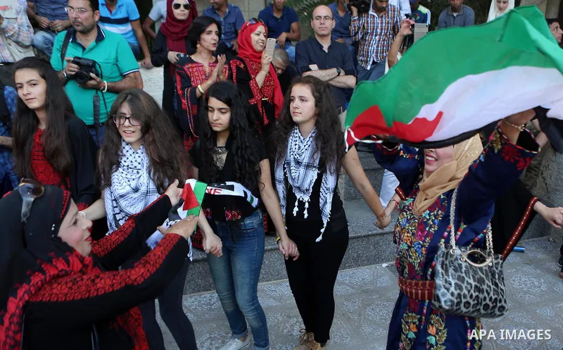 Palestinians perform a traditional dance during a ceremony of Palestinian Traditional Dress and Heritage Day in the West Bank city of Ramallah, on July 25, 2016. Photo by Shadi Hatem