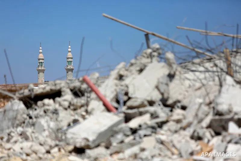 Palestinians inspect the rubble of a Palestinian house after it was demolished by Israeli troops in the West Bank village of Qalandia near Ramallah July 26, 2016. Photo by Shadi Hatem