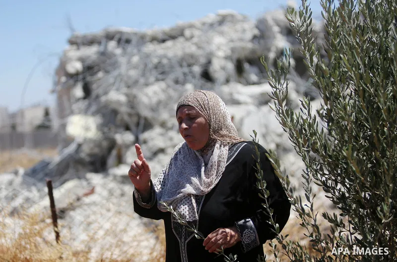 Palestinians inspect the rubble of a Palestinian house after it was demolished by Israeli troops in the West Bank village of Qalandia near Ramallah July 26, 2016. Photo by Shadi Hatem
