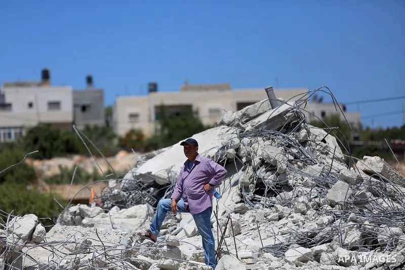 Palestinians inspect the rubble of a Palestinian house after it was demolished by Israeli troops in the West Bank village of Qalandia near Ramallah July 26, 2016. Photo by Shadi Hatem
