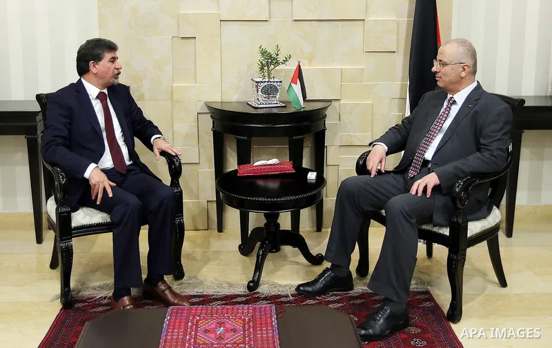 Palestinian Prime Minister Rami Hamdallah meets with Anwar Abdul Hadi, head of the political department at the PLO office in Syria, in the West Bank city of Ramallah on July 26, 2016. Photo by Prime Minister Office