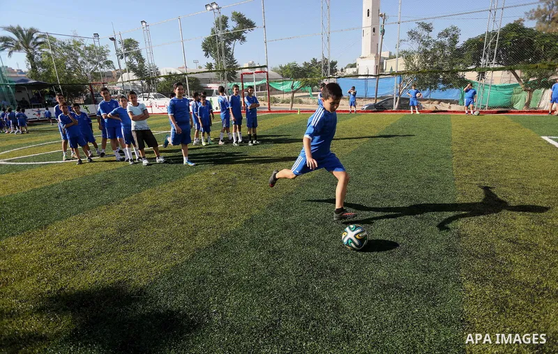 Palestinian boys take part in a training season for football school at Al Jazeera club in Gaza city, on July 26, 2016. Photo by Mohammed Asad