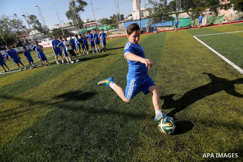 Palestinian boys take part in a training season for football school at Al Jazeera club in Gaza city, on July 26, 2016. Photo by Mohammed Asad