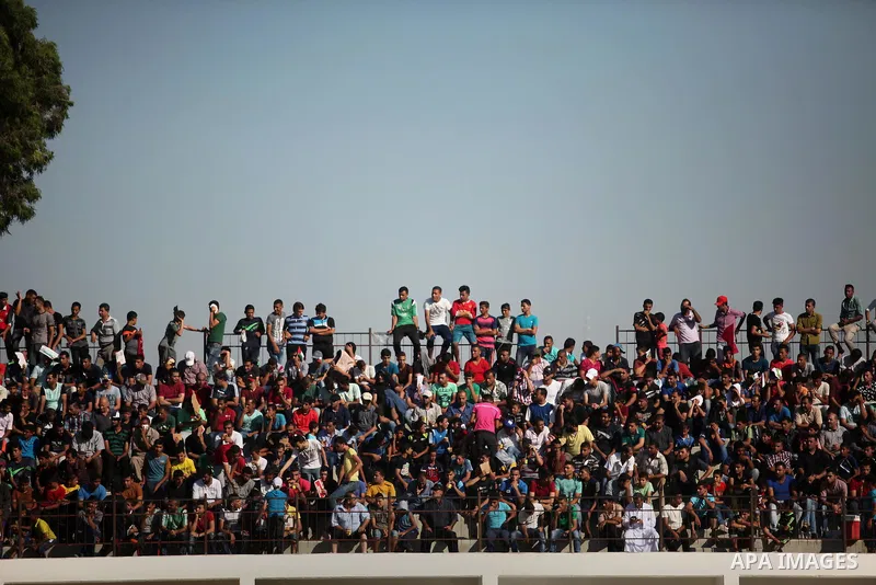 Palestinian spectators watch the first leg of the Palestine Cup final soccer match between Gaza Strip's Khan Younis Youth and Hebron's Al-Ahly at al-Yarmouk stadium in Gaza City July 26, 2016. Photo by Ashraf Amra