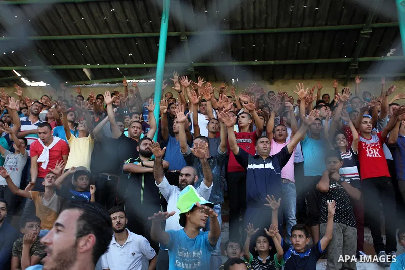 Palestinian spectators watch the first leg of the Palestine Cup final soccer match between Gaza Strip's Khan Younis Youth and Hebron's Al-Ahly at al-Yarmouk stadium in Gaza City July 26, 2016. Photo by Ashraf Amra