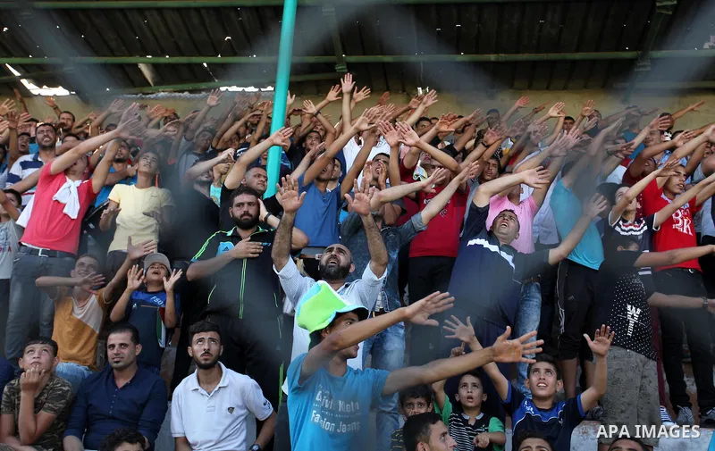 Palestinian spectators watch the first leg of the Palestine Cup final soccer match between Gaza Strip's Khan Younis Youth and Hebron's Al-Ahly at al-Yarmouk stadium in Gaza City July 26, 2016. Photo by Ashraf Amra