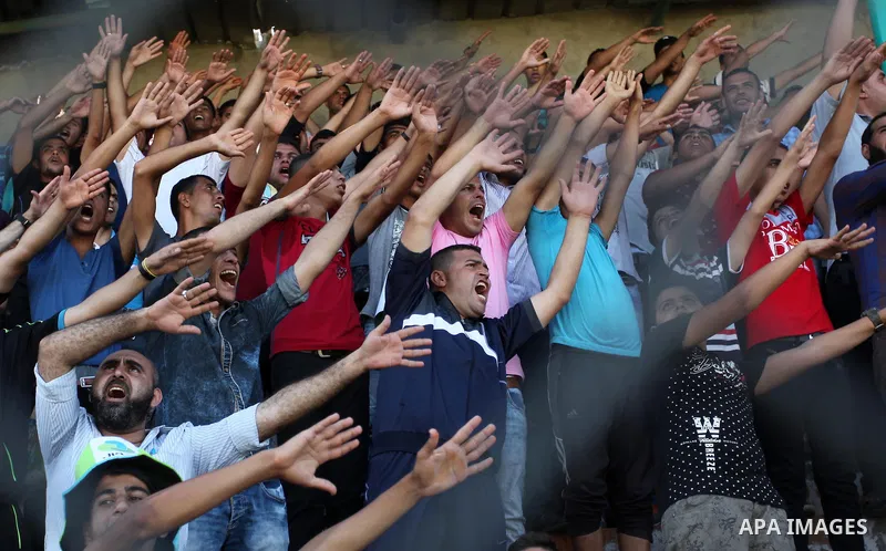 Palestinian spectators watch the first leg of the Palestine Cup final soccer match between Gaza Strip's Khan Younis Youth and Hebron's Al-Ahly at al-Yarmouk stadium in Gaza City July 26, 2016. Photo by Ashraf Amra